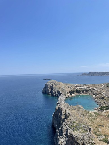 Rocky coastline and a turquoise cove on the open sea