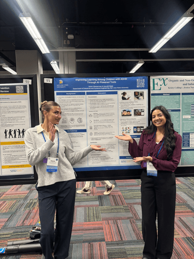Keren and a colleague presenting their research poster at a conference